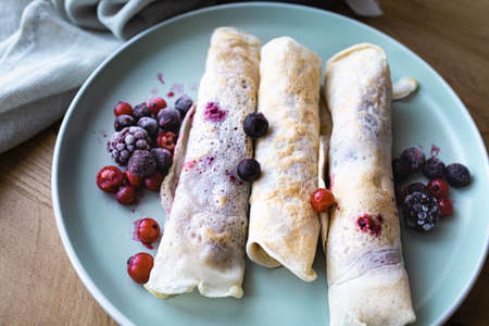 Homemade crepes with raspberry and blueberry jam. Healthy breakfastの写真素材
