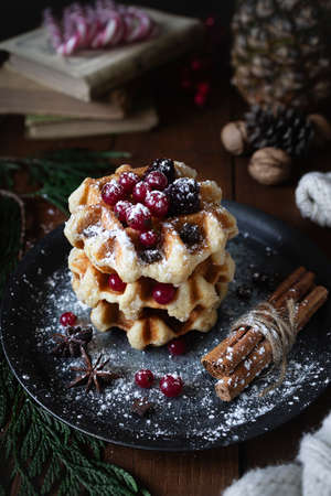 Waffles with blackberries and currants. Christmas sweets. Table with desserts and Christmas decorations. Still life with sweetsの写真素材