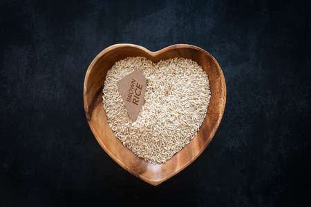 Heart-shaped bowl with brown riceの写真素材