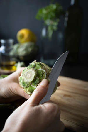 Cleaning and preparing artichokes in the kitchen. Cooking artichokes. Homemade healthy foodの写真素材