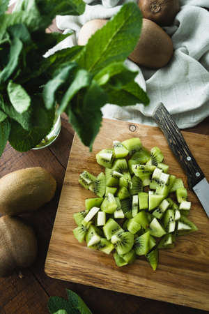 Fresh and ripe kiwi sliced ââon a wooden kitchen boardの写真素材