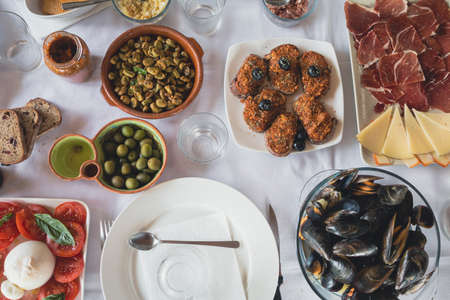 Top view of a table with tapas. Plates with food ready to eat. Table with snacks.の写真素材
