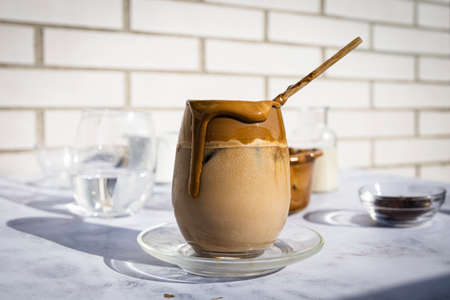 Coffee with ice. Dalgona coffee. Creamy coffee with ice and almond milk. Ideal drink for summer