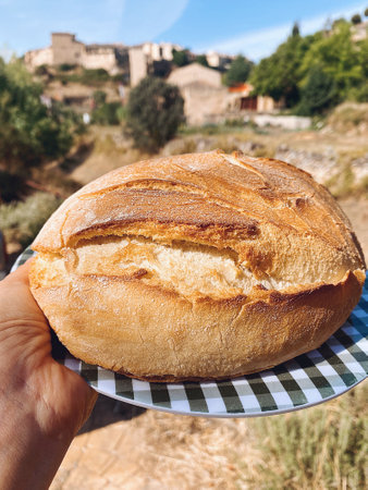 Rustic round bread buying in Pedraza, medieval town of Segovia in Spain