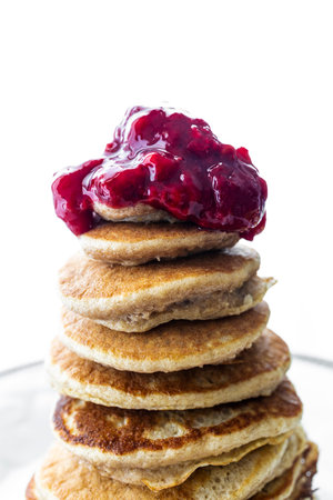 Healthy gluten-free oatmeal, egg and banana pancakes with homemade raspberry jam. Healthy breakfast.