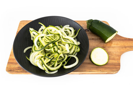 Homemade zucchini spaghetti. Homemade zucchini noodles. Vegetarian and raw dish.の写真素材