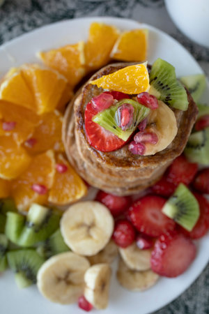 Pancakes with fresh fruit. Fruit salad with gluten-free pancakes. Healthy breakfast full of vitamins