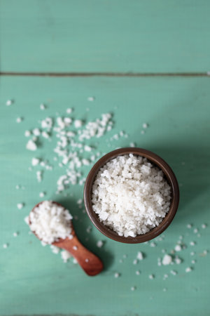 Coarse salt on a turquoise wooden background. Coarse salt from the marshes of the ÃŽle de RÃ© in...