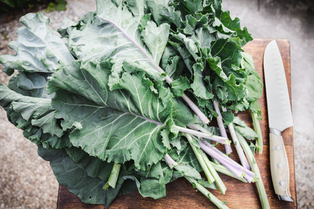 Kale vegetable on a cutting board with a knife in the background
