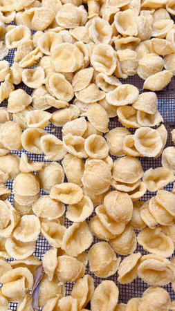 Freshly made orecchiette pasta, a traditional specialty from Bari, Puglia, crafted by local women at Arco Bassoの写真素材