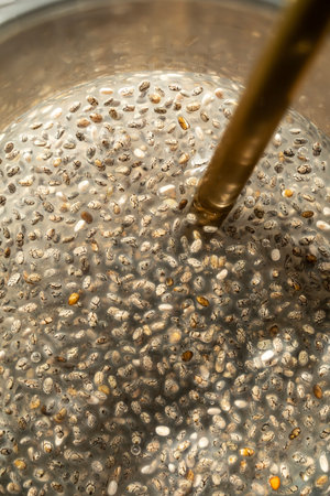 A highly detailed close-up image of soaked chia seeds, focusing on the gel-like texture (mucilage)...