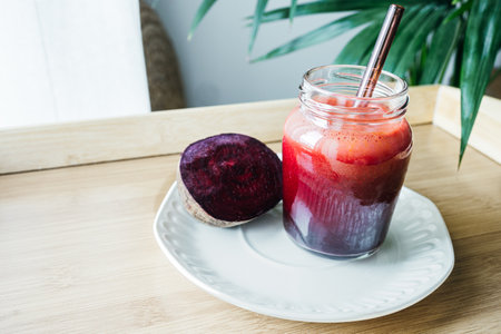 A vibrant beetroot smoothie served in a clear glass, showing its deep red color and thick texture. Known for its antioxidant, anti-inflammatory, and blood pressureâsupporting benefits, this drink is perfect for health and wellness content.の写真素材