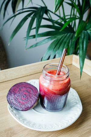 A vibrant beetroot smoothie served in a clear glass, showing its deep red color and thick texture. Known for its antioxidant, anti-inflammatory, and blood pressureâsupporting benefits, this drink is perfect for health and wellness content.の写真素材