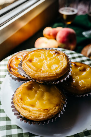 A beautifully styled serving of PastÃ©is de BelÃ©m, Portugal's most famous custard tarts,の写真素材