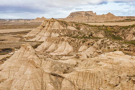 Panoramic view of the Bardenas Reales natural park in Navarra, Spain, a semi-desert landscape with eroded hills, clay formations, and unique shapes created by wind and water.の写真素材