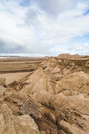 Panoramic view of the Bardenas Reales natural park in Navarra, Spain, a semi-desert landscape with eroded hills, clay formations, and unique shapes created by wind and water.の写真素材