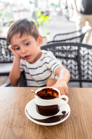 Adorable child enjoying a warm cup of hot chocolateの写真素材