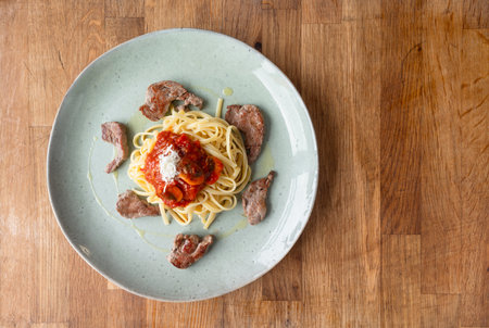 Savor the richness of our Spaghetti with tomato and mushroom sauceâa delightful harmony of tangy tomatoes, earthy mushrooms, and perfectly cooked pastaの写真素材