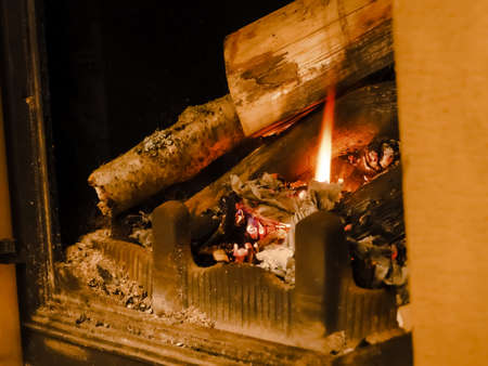 Beautiful flame fireplace logs. Wood burning bright flames in a modern fireplace with glass doorの写真素材