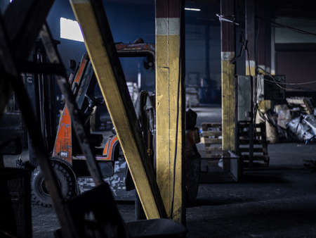 Red forklift parked in modern factory warehouse yellow pillarの写真素材