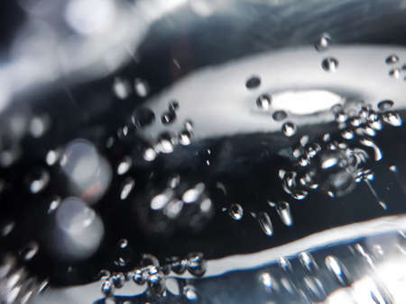 Macro Oxygen bubbles in water on a dark blue background, concept such as ecology and other your...