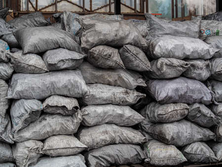 pile of bags of soil and coal, agriculture, Soil bag stack in warehouse. Organic Fertilizer Bag in the market. (selective focus). Background bagsの写真素材