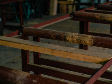 Woods pellet production. Close-up photo of equipment. Woodworking forestry: machinery and equipment for pressing and sawing sawn timber. Red conveyorの写真素材