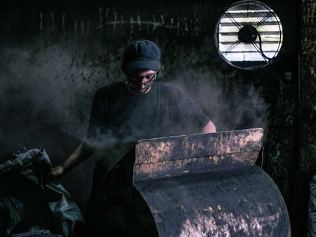 A coal plant worker during a shift in Cherepovets Russia. He works in very difficult and dangerous conditions. Dark and dustyの写真素材