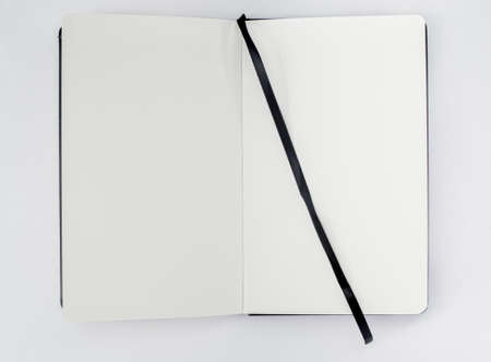 Unfold open notebook, book with blank white pages and black ribbon, bookmark on light background....