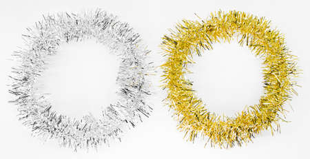 Round circles of silver and golden tinsel. New year decorations on a white background. Christmas...