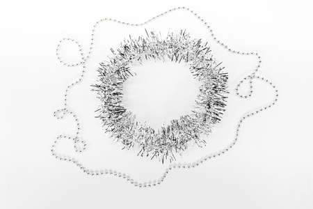 Beads, chain of balls, round circle of silver tinsel. New year decorations on a white background. Christmas conceptの写真素材