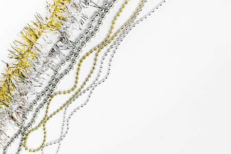 Diagonal silver and golden chain with balls, beads, yellow tinsel. Christmas concept. New year...