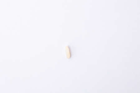 grain of white rice in the middle of light background, close-up top view isolatedの写真素材