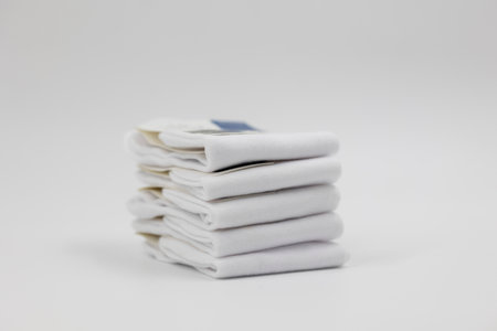 stack of new white socks isolated on light background, close upの写真素材