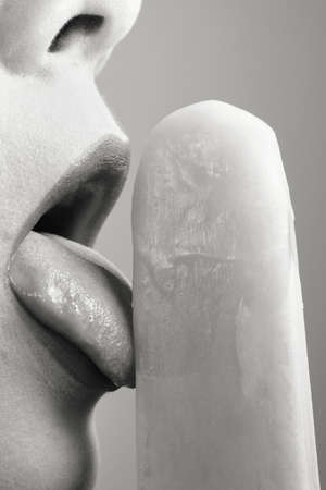 Close-up of a woman's mouth with an ice pop.