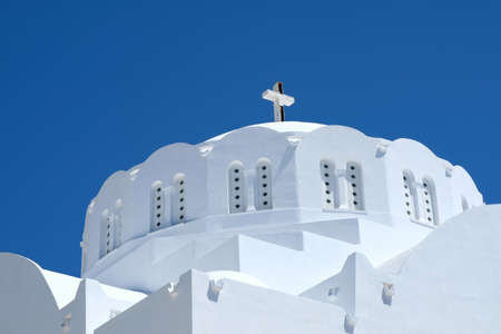 A beautiful white Orthodox Church and an amazing blue sky in Santorini Greeceの写真素材
