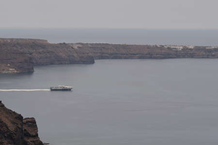 A cruise ship on the caldera of Santorini, Greeceの写真素材