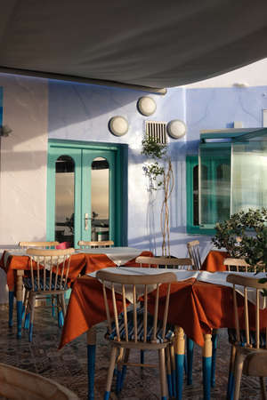 Santorini, Greece - May 5, 2021 : View of a beautiful decorated terrace of a restaurant with tables, chairs, and pillows in Fira Santorini Greeceのeditorial素材