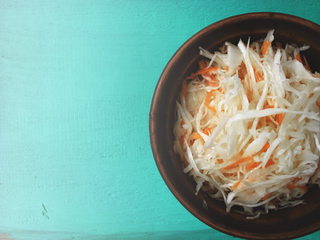 Village salad in an earthenware dish. On the vintage table.の写真素材