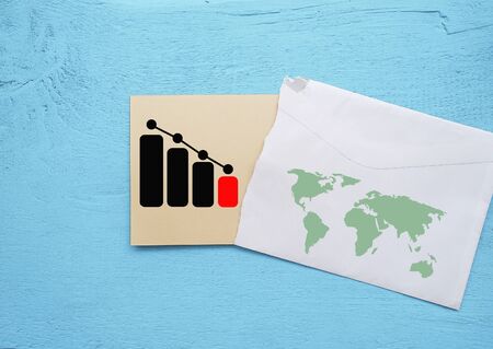 Declining graph. Printed on paper. On a wooden texture.の写真素材