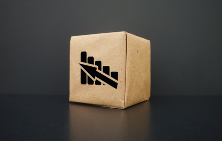 On a dark background a box. It shows a graph going up. Business graph rises.の写真素材