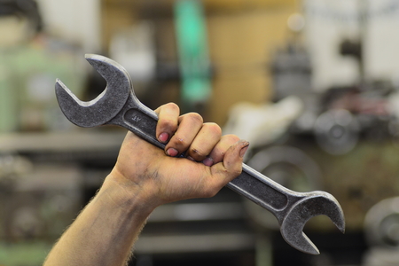 Dirty hand of working man with spanner wrench の写真素材