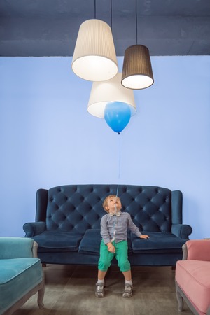 Positive child having fun with balloon. Children celebration background.の写真素材