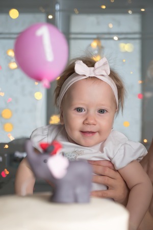 Happy children. Birthday party background. Smiling girl and birthday cake. Birthday, one year. One...