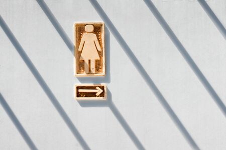 Sign and symbol of public wc on clay plate. Public toilet on plate. Public womens toilet. Mens restroom. Toilet for the disabled.の写真素材