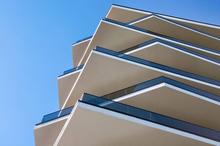 Modern building. Modern hotel building with facade of concrete and glass. Modern skyscraper steel and glass architecture. Architectural minimalism of facade. Unusual facade of contemporary house.のeditorial素材