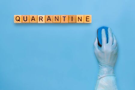 Person quarantined coronavirus in medical gloves. Self-quarantine, self-isolation concept. Coronavirus quarantine background. Stay at home concept. Hand in medical glove with computer mouse.の写真素材