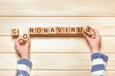 Children and coronavirus. Children psychology. Kids hands laying out coronavirus word. Pandemic,...
