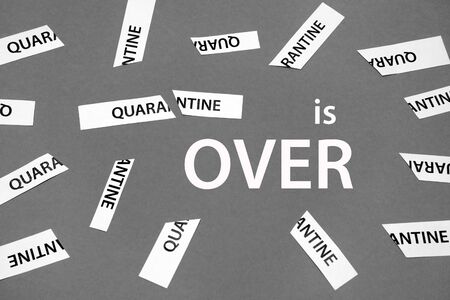 End of a coronavirus quarantine concept. COVID-19 isolation is over. Finish of isolaion. Close up. Grey background. The end of Coronavirus COVID 19 Pandemic. Back to normal life. Quarantine is overの写真素材
