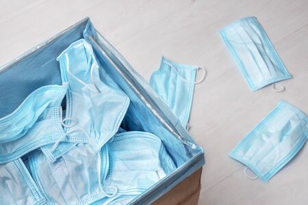 Used medical mask thrown away. Utilization of protection during coronavirus. The end of pandemic. Quarantine time finishing. Trash bag full of used medical masks. Pollution of environment.の写真素材